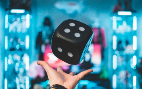 Someone throwing a dice in a game.